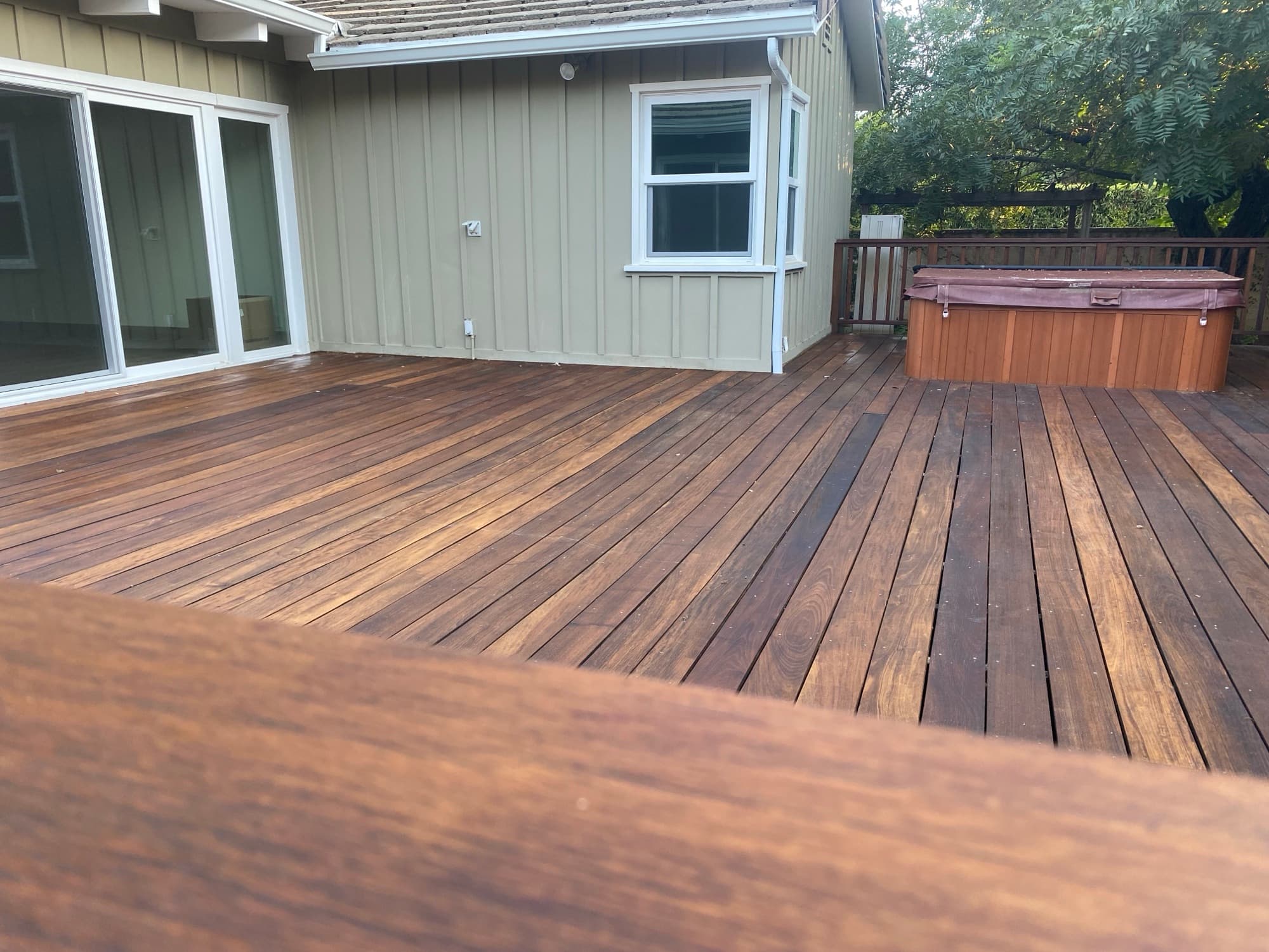 Rich-stained wood deck after refinishing.